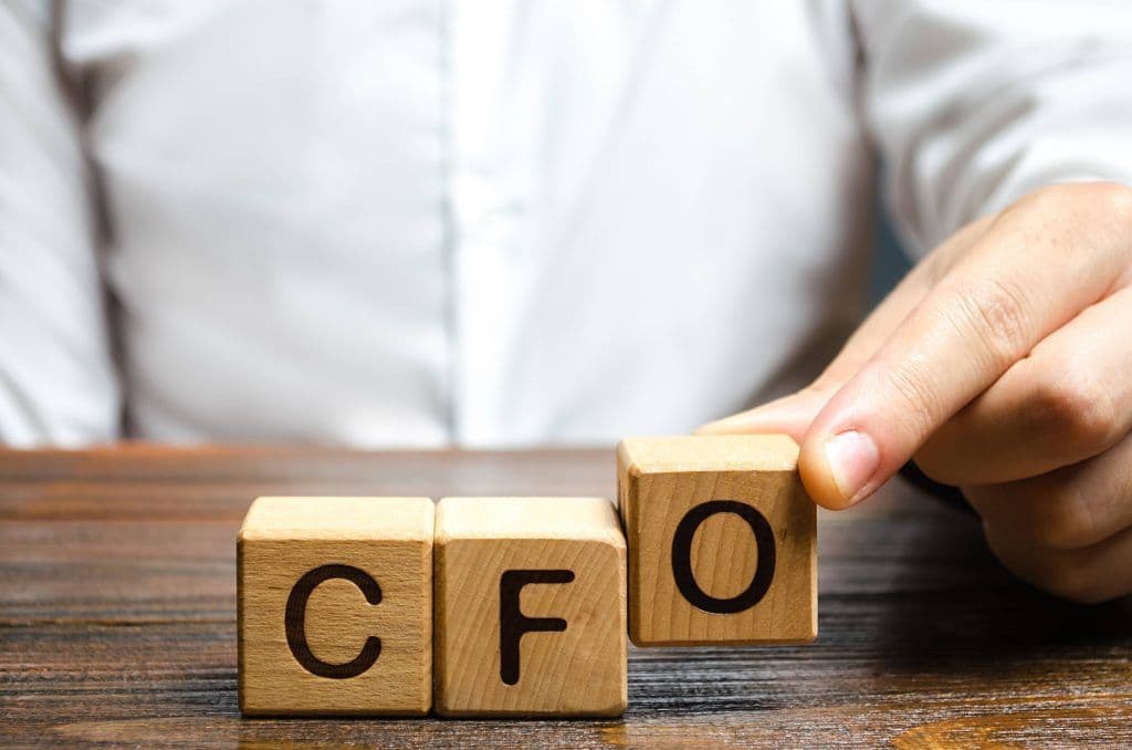 CFO reviewing strategic dashboard with financial indicators and projections for 2026 planning
